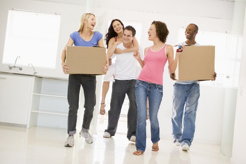 Loading boxes and protected furniture into a moving van in central London