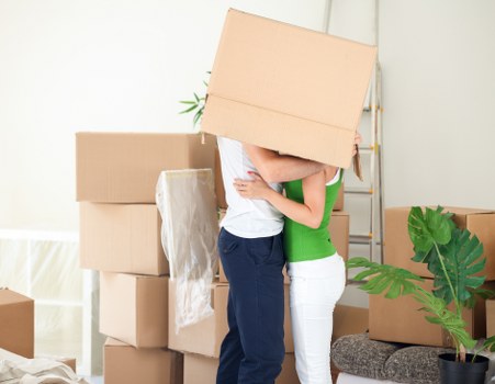 Professional movers carrying furniture through a Marylebone property